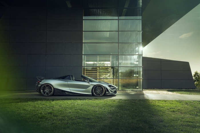 Silver McLaren 720S Spider parked by modern building