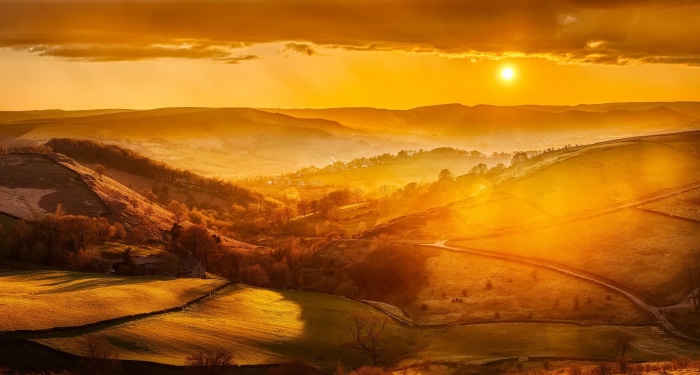Golden Sunset Over Rolling Hills and Valleys
