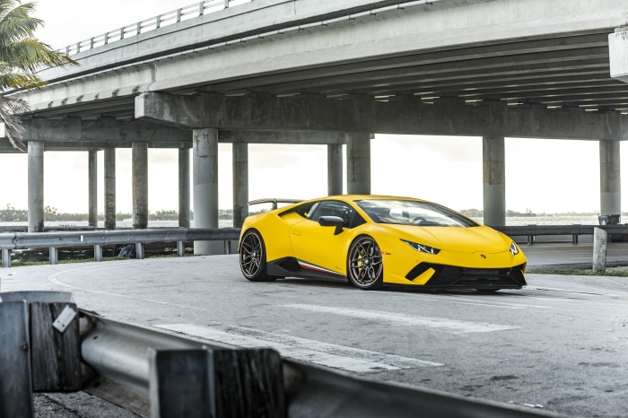 Yellow Lamborghini Huracan Performante under a bridge