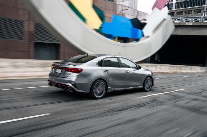 Silver Kia Forte GT 4K driving on a city street
