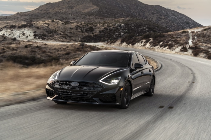 Black Hyundai Sonata N Line driving on a winding road