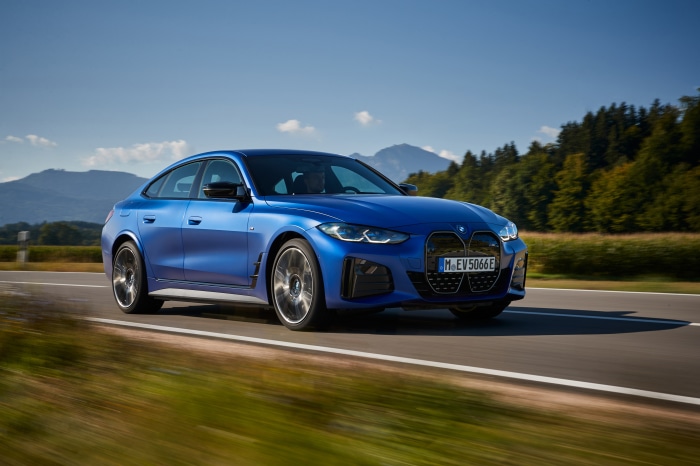 Blue BMW i4 M50 driving on a road