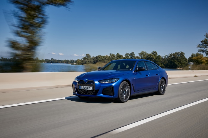 Blue BMW i4 M50 driving on a road