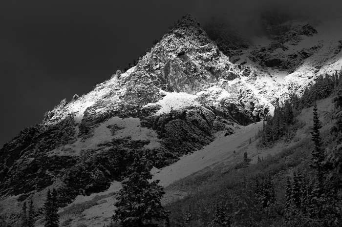 Snow-covered mountain peak in black and white