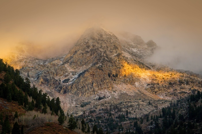 Mountain peak in fog with golden sunlight in Utah