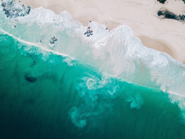 Aerial view of a beach with turquoise waves