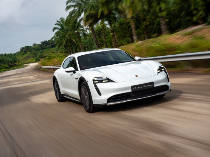 White Porsche Taycan 4S Cross Turismo driving on a road