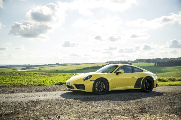 Yellow Porsche 911 Carrera GTS on a rural road