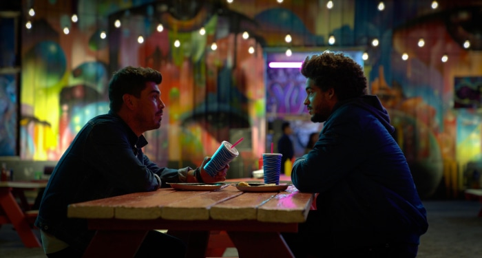 Two men sitting at a table with drinks