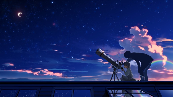 Boy and adult looking through telescope at night sky