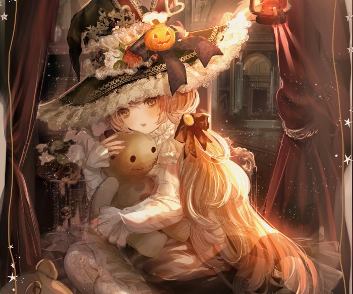 Girl in witch hat holding a teddy bear