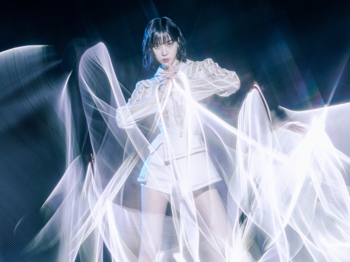 Winter from Aespa in white outfit with light effects