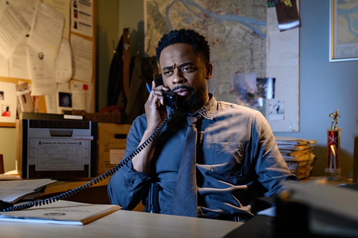 Dulé Hill on the phone in an office