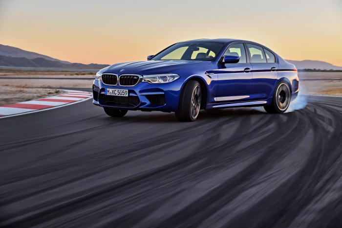 Blue BMW M5 F90 drifting on a race track