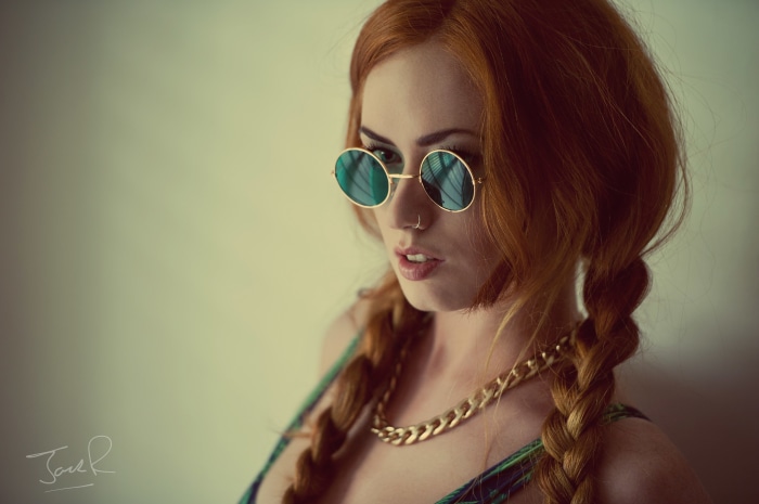 Redhead woman with sunglasses and pigtails