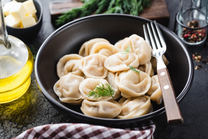 Bowl of dumplings with dill and butter