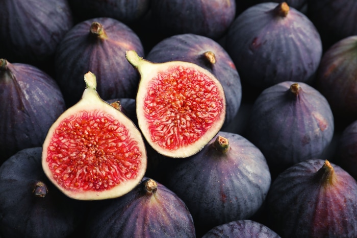 Close-up of ripe figs, one cut in half