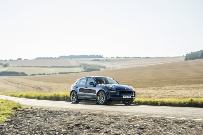 Blue Porsche Macan SUV on a country road
