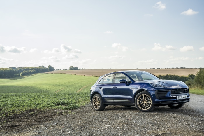 Blue Porsche Macan SUV on a gravel road