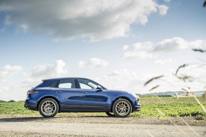 Blue Porsche Macan SUV on a gravel road