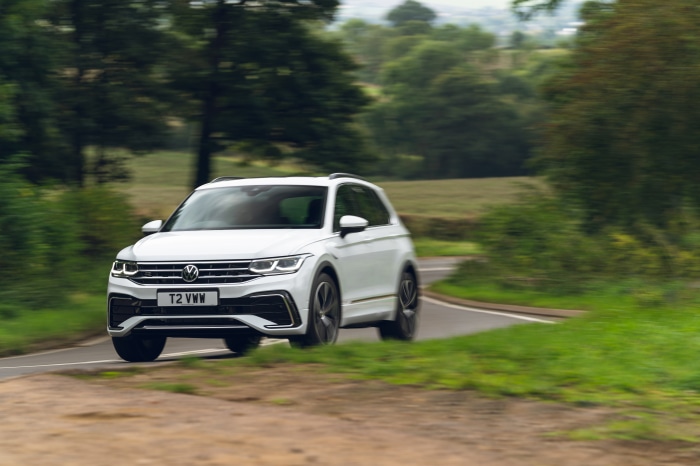 White Volkswagen Tiguan R-Line driving on a country road