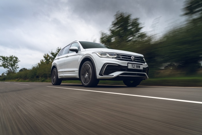 White Volkswagen Tiguan R-Line driving on a road