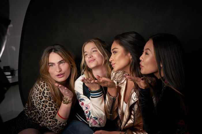 Four women blowing kisses