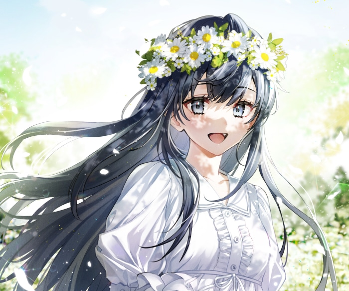 Girl with a flower wreath in a field