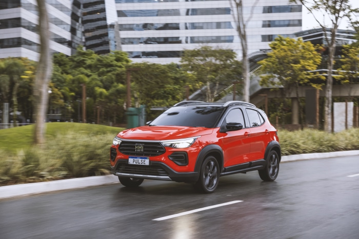 Red Fiat Pulse Audace Turbo SUV driving on a wet road