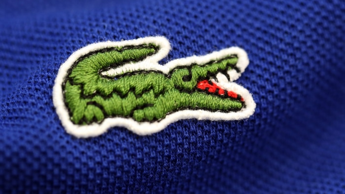 Lacoste logo embroidered on blue fabric