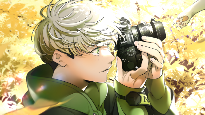 Boy with Nikon camera and cat paw