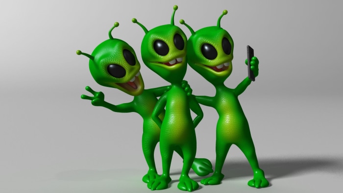 Three green aliens taking a selfie