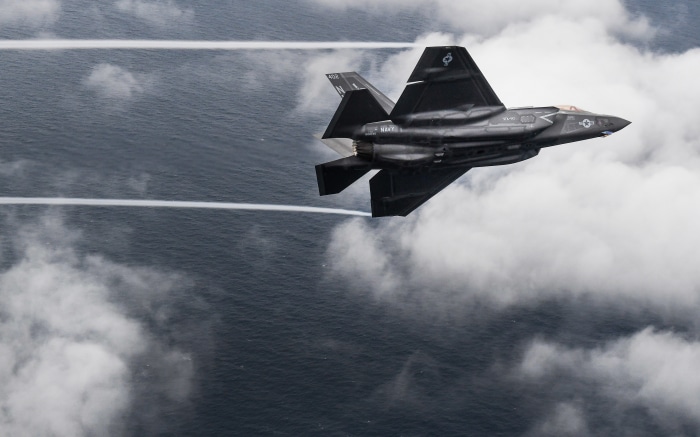 F-35C Lightning II jets fly over the ocean
