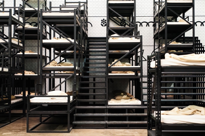 Bunk beds in a dormitory with white tiled walls