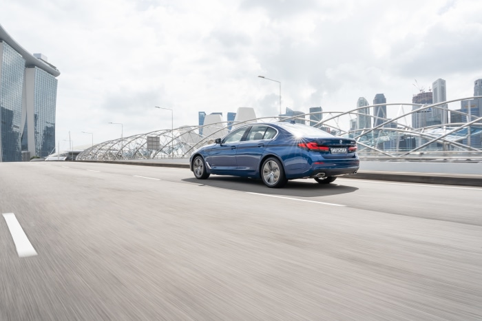 Blue BMW 5 Series 530e Luxury Line on road