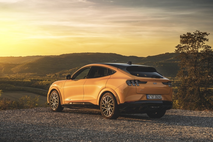 Ford Mustang Mach-E GT parked on gravel with sunset background