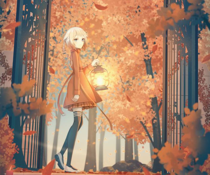 Girl holding a lantern in autumn forest