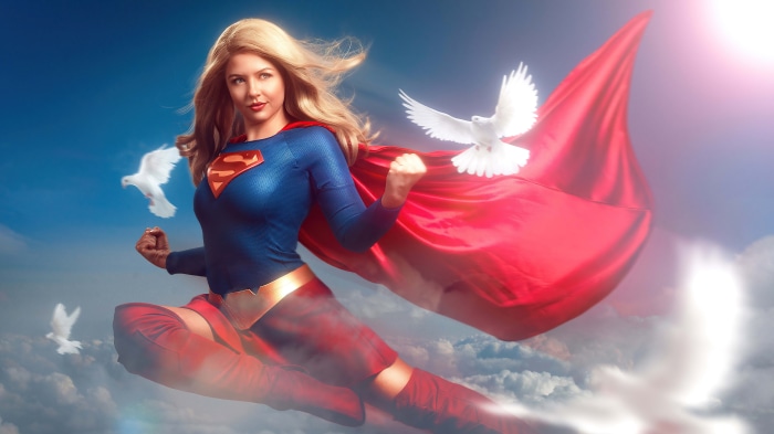 Supergirl from DC Comics flying with doves