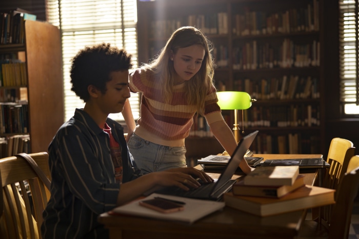 Elisha Henig and Megan Scott in a library