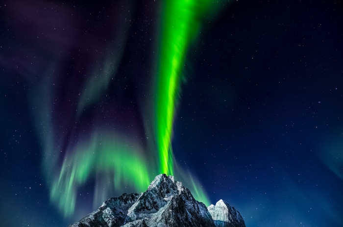 Aurora Borealis over snow-capped mountains