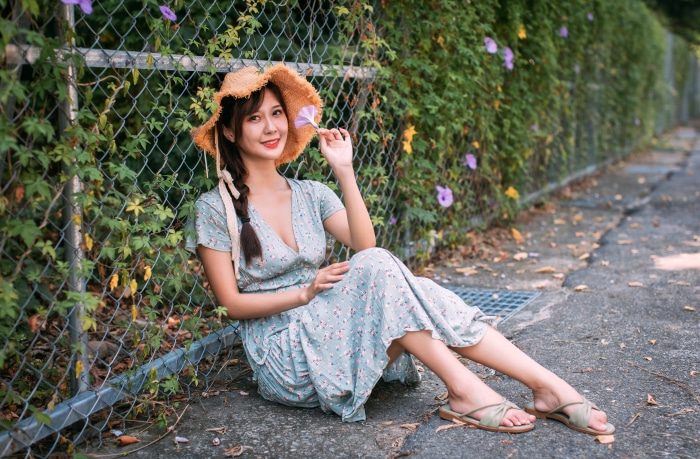 Asian woman in a floral dress and straw hat