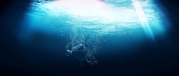 Girl underwater with light rays