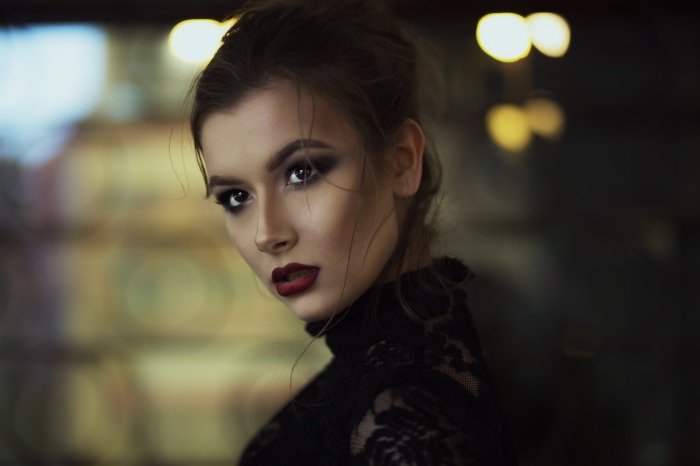 Model with dark makeup and red lipstick