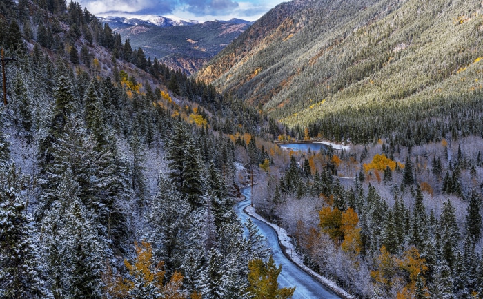 Colorado Valley with Snow-Dusted Forest and Winding Road