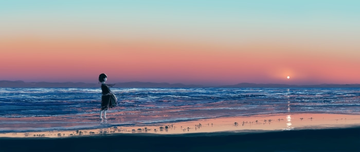 Girl watching sunrise over the ocean