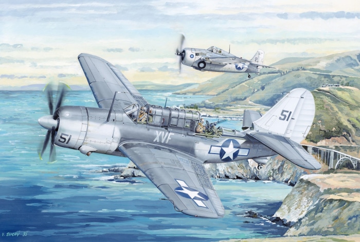 Curtiss SB2C Helldiver aircraft flying over a coastal landscape