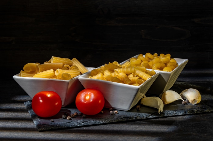 Still life of pasta, tomatoes, and garlic