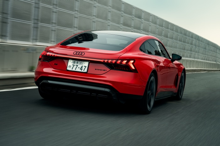 Red Audi RS E-Tron GT driving on road