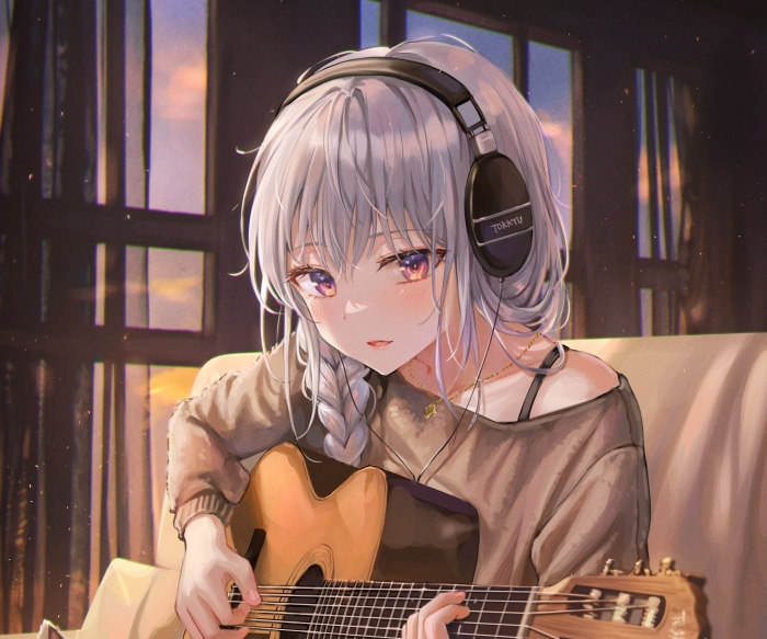 Girl with headphones playing guitar