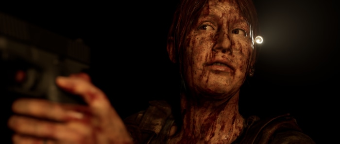 Woman covered in blood holding a gun